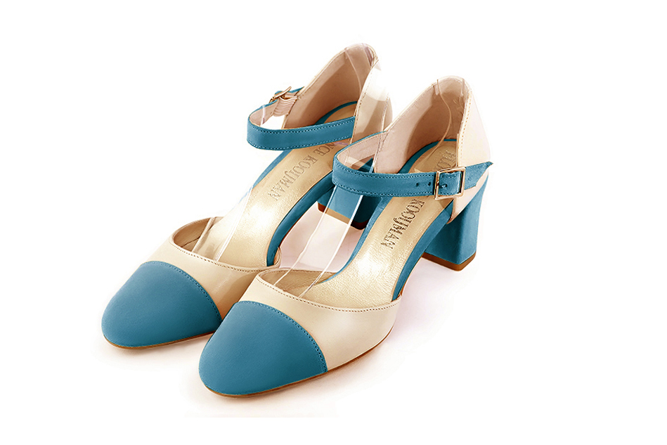 Peacock blue and champagne white open side elegant shoes, with an instep strap. Round toe. Medium block heels.